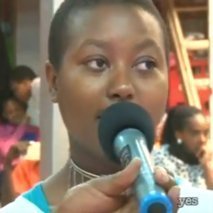 Loice Wangoi, a smiling woman giving testimony of supernatural healing from chronic pain and restoration of her health through Ebenezer TV prayer ministry